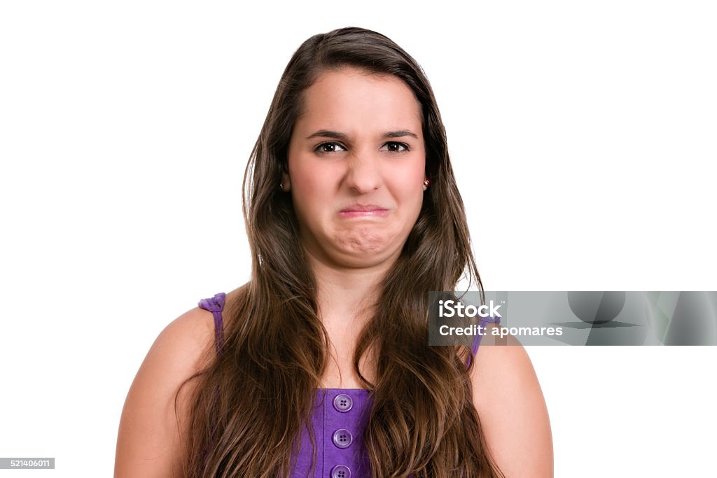 Disgunting and unpleasant smell. Hispanic  young woman. Expression series. Disgunting and unpleasant smell. Hispanic young woman. Expression series. Isolated on white with clipping path. Disgust Stock Photo