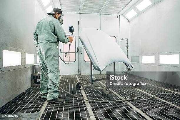 Mechanic In Painting Booth Spray The Hood Of A Car Stock Photo - Download Image Now - Car, Painting - Activity, Painting - Art Product