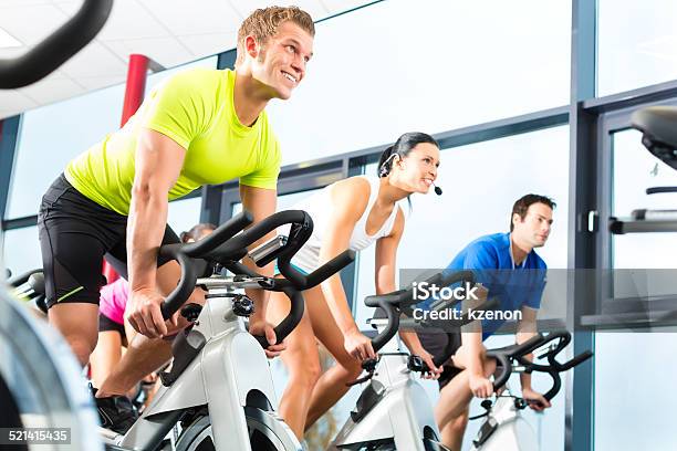 Young People Exercising In The Gym Stock Photo - Download Image Now - Gym, Health Club, Spinning