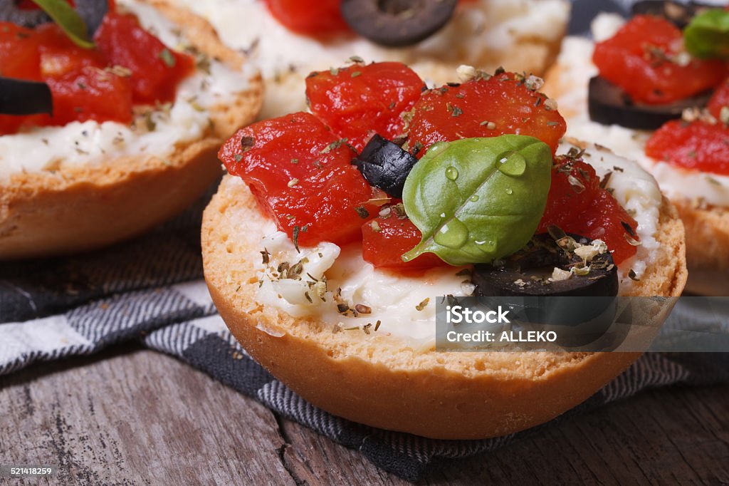 Italian bruschetta with tomatoes, feta cheese and olives Italian bruschetta with tomatoes, feta cheese and olives close up Antipasto Stock Photo