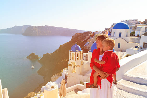 istock mother and son enjoying view of santorini 521418432