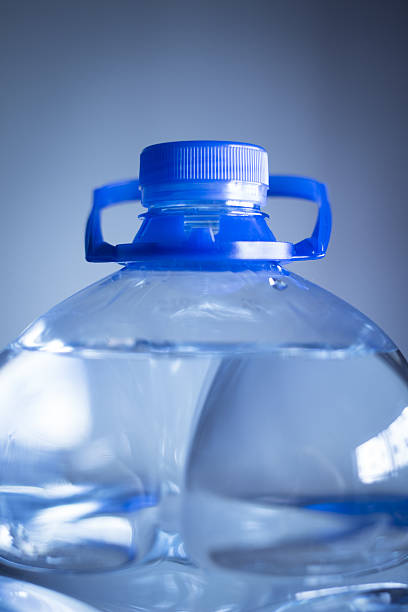 istock Isolated plastic water bottle plain blue background studio shot close-up 521420565