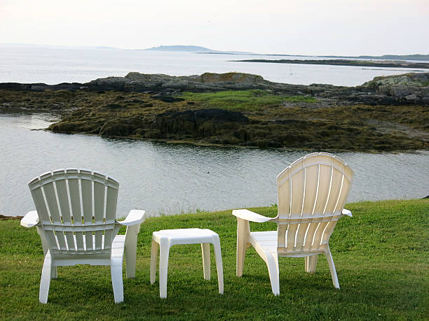 istock Two White Empty Adirondack Vacation Chairs by Ocean Coast, Maine 521421025
