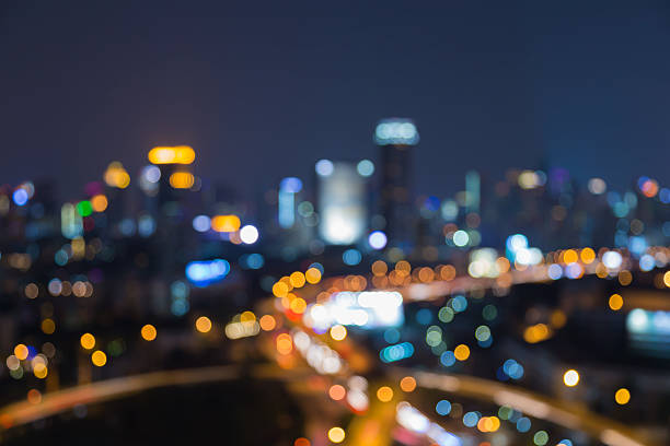 istock Abstract blurred bokeh lights, interchanged road with office building 521425648