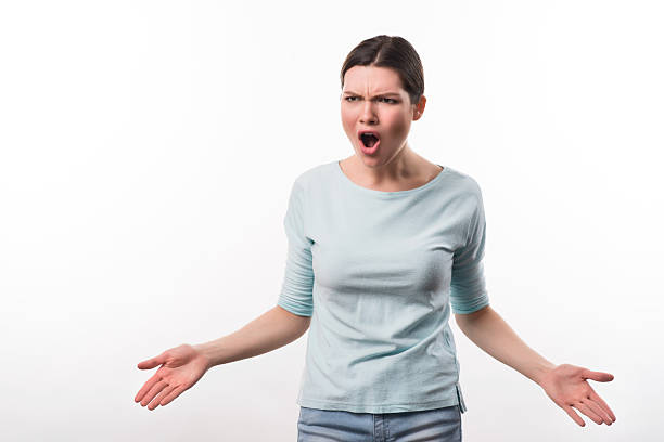 istock Emotional  angry girl standing isolated on white background 521426024