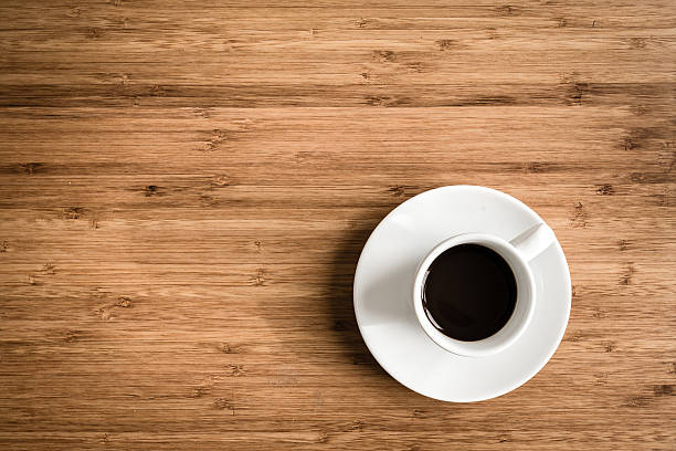 istock Cup of hot coffee in white cup on wooden table 521426076