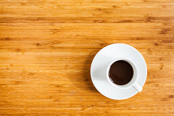 istock Hot black coffee in white cup on wooden table 521426102