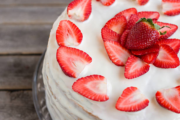 istock White cake decorated with strawberries on a gray wooden table 521427286
