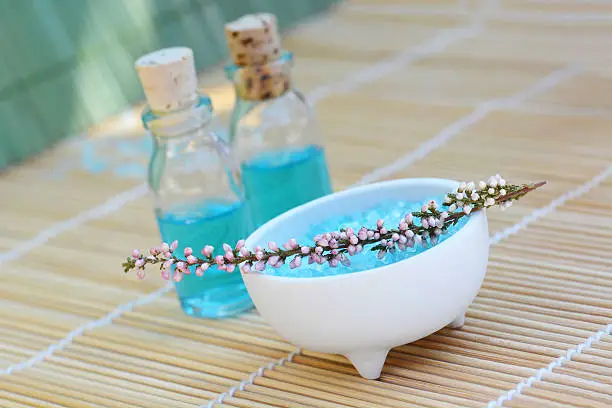 Bowl of scented bath-salt, surrounded by spa products