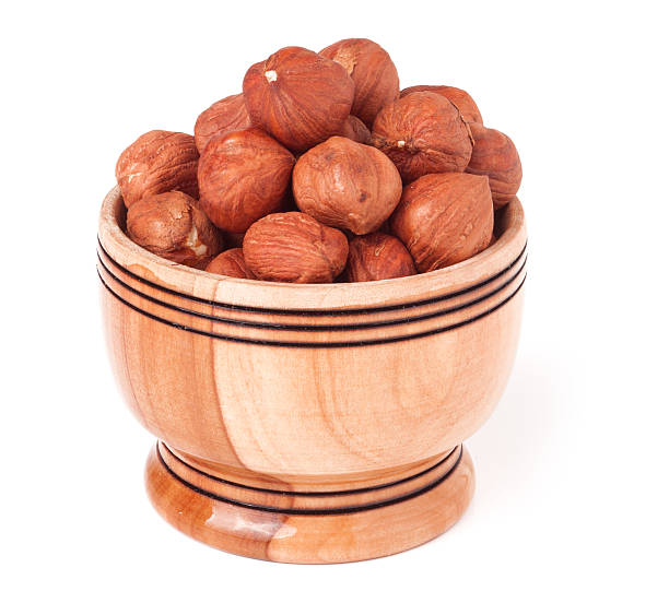 istock peeled hazelnuts in a wooden bowl on  white background 521429390