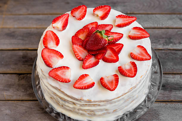istock White cake decorated with strawberries on a gray wooden table 521429460