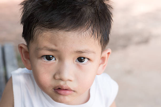 istock Asian kid with natural loose tooth. 521430122