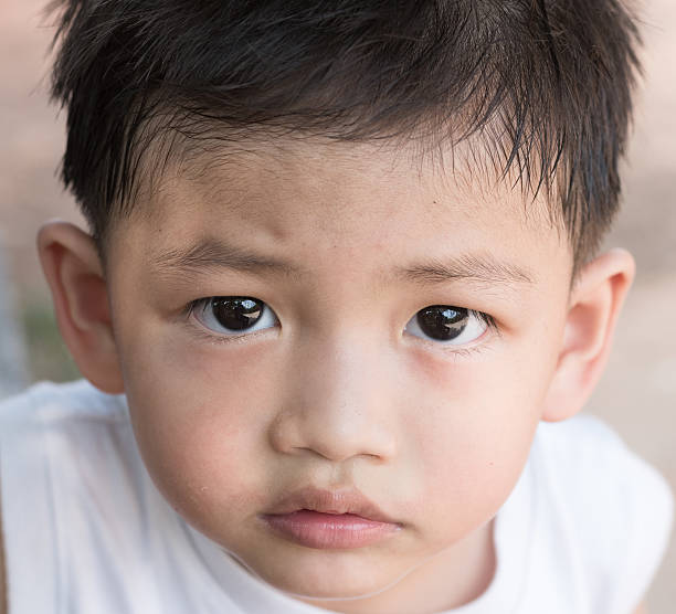 istock Asian kid with natural loose tooth. 521430328