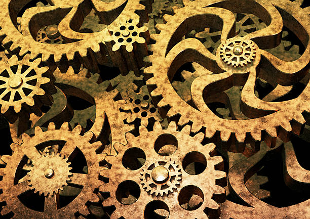 istock Gears wheels from bronze metal on black background. 521432540