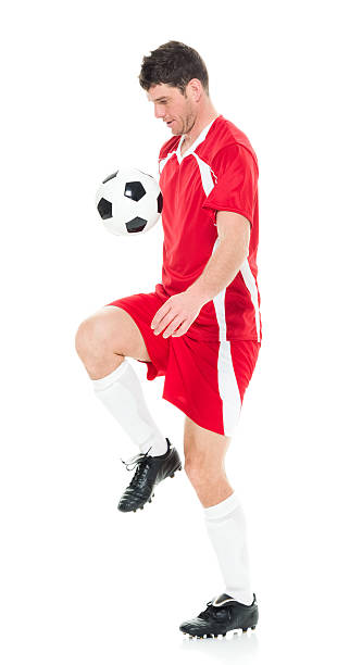 istock Male soccer player juggling 521432708