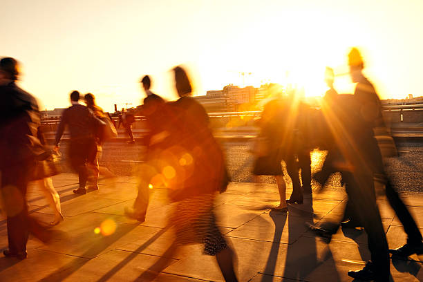 istock Crowd of Blurred Commuters in Rays of Setting Sun 521435399