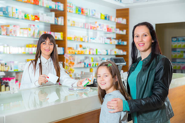 istock Mother with child at pharmacy 521436095