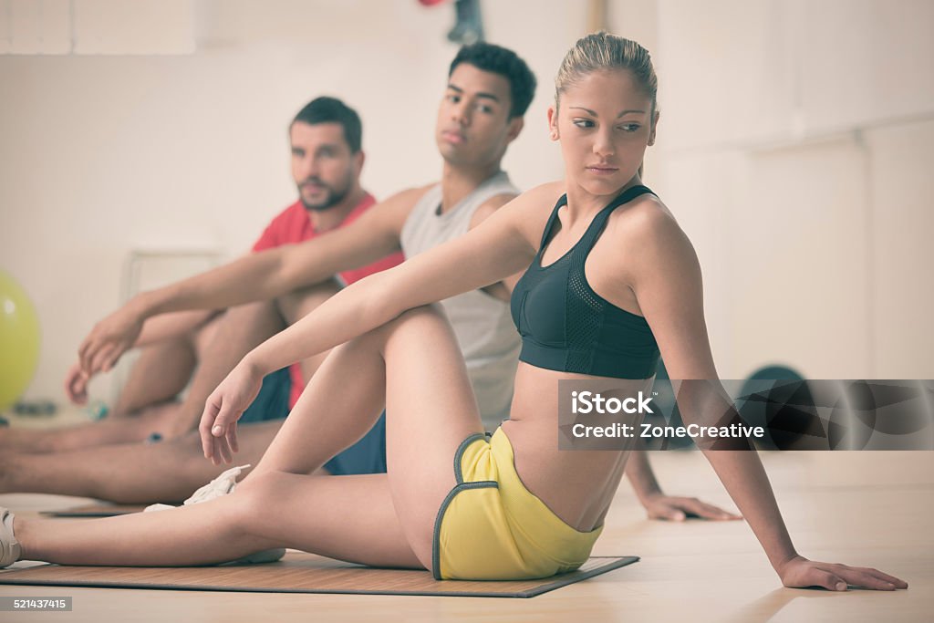 Group of young people doing stretching exercise in gym 20-24 Years Stock Photo