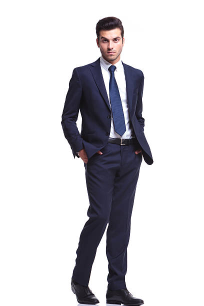 istock elegant business man walking with his hands in his pocket 521438443
