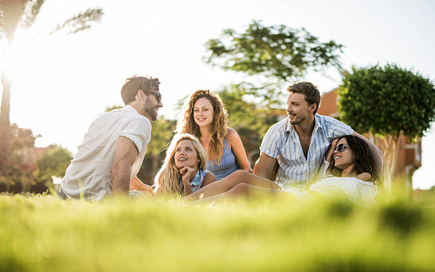 istock Smiling young people communicating in the park. 521438753