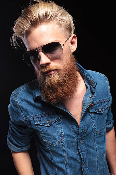 istock man wearing suglasses and blue shirt posing for the camera 521451483