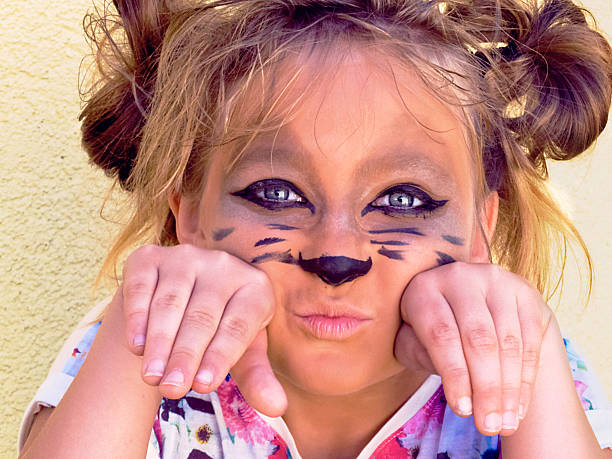 girl of ten years embellished cat face stock photo