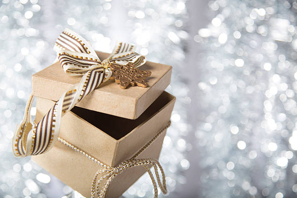 istock christmas gift box with golden star, bow and ribbon 521454505