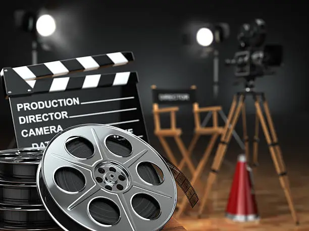 Photo of Video, movie, cinema concept. Retro camera, reels, clapperboard