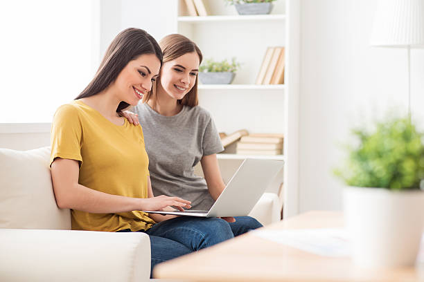 istock Positive girls sitting on the couch 521458546