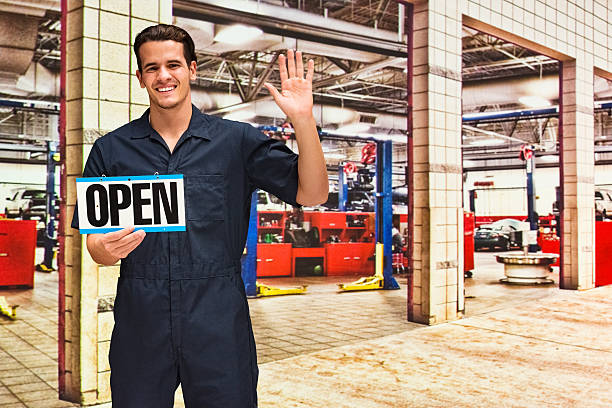 istock Mechanic showing open sign 521459490