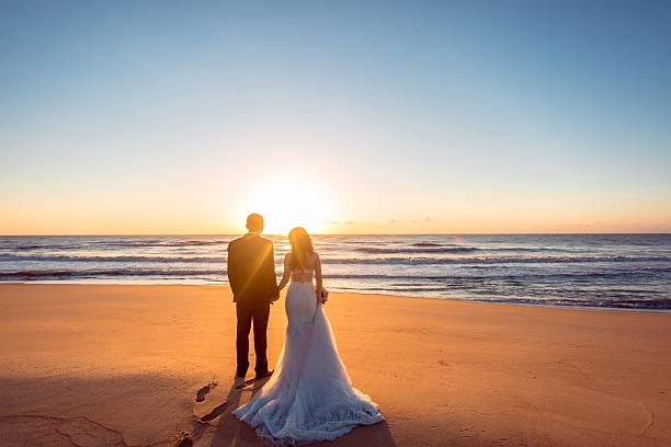 istock Beautiful bride and groom at the beach 521459962