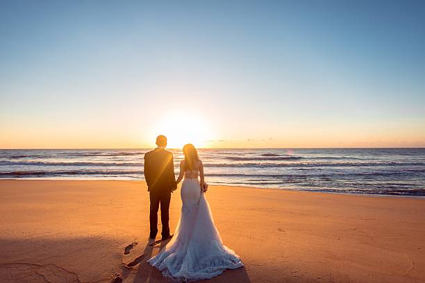 Beautiful bride and groom at the beach Happy couple honeymoon photos stock pictures, royalty-free photos & images