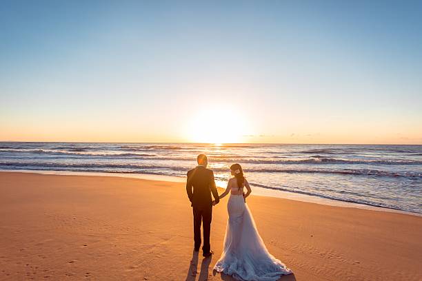 istock Beautiful bride and groom at the beach 521460012