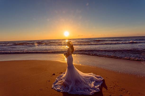 istock Beautiful bride and groom at the beach 521460100