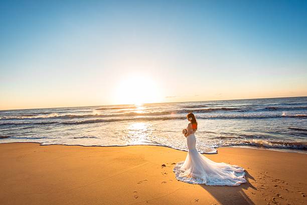 istock Beautiful bride and groom at the beach 521460138