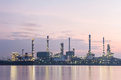 Refinery plant with water reflection in Bangkok, sunrises and blue cloud background