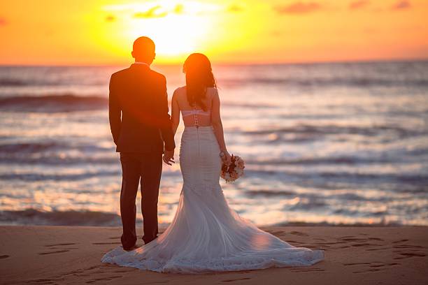 istock Beautiful bride and groom at the beach 521460974