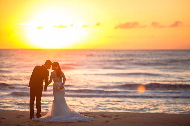 istock Beautiful bride and groom at the beach 521461090