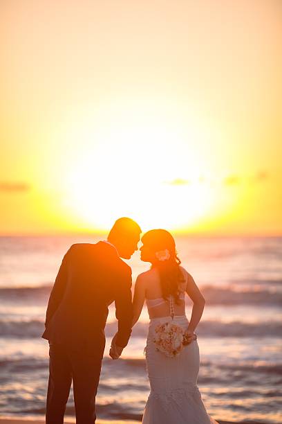 istock Beautiful bride and groom at the beach 521461126
