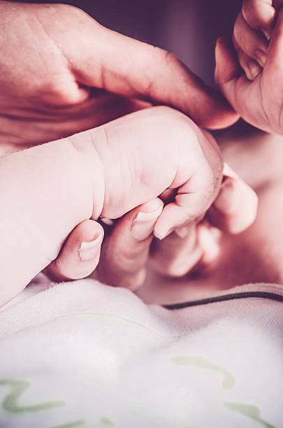 istock Baby playing with mother's hands 521461250