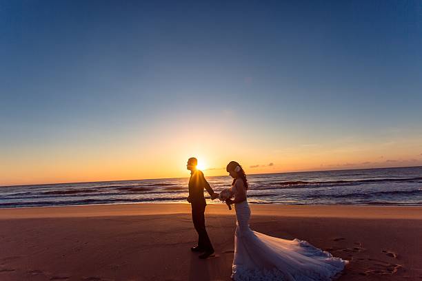 istock Beautiful bride and groom at the beach 521461346