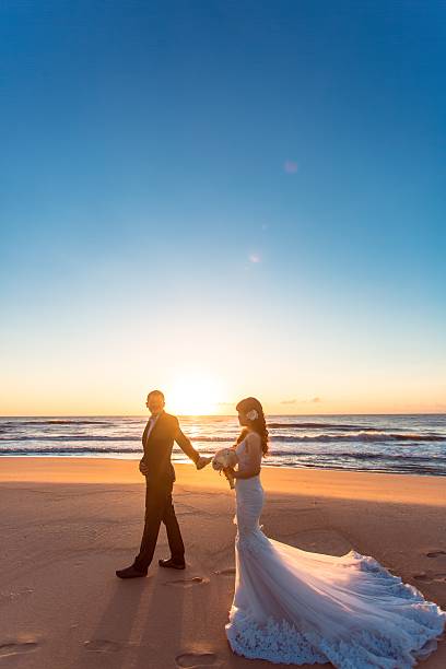 istock Beautiful bride and groom at the beach 521461388