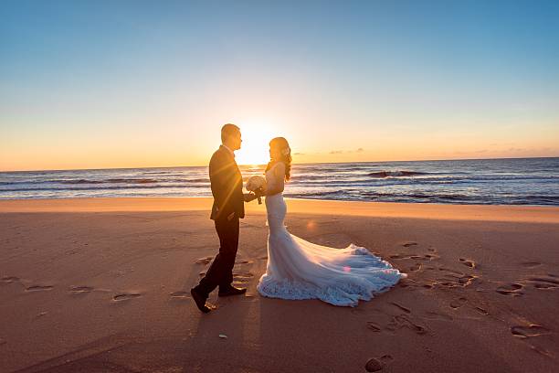 istock Beautiful bride and groom at the beach 521461420