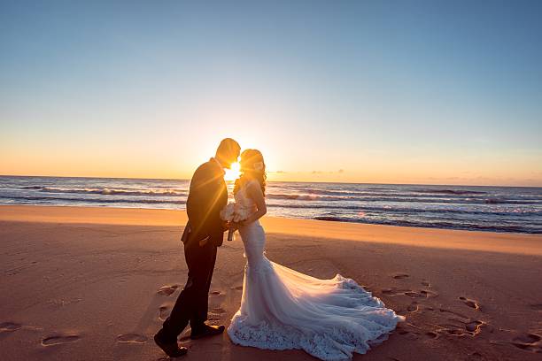 istock Beautiful bride and groom at the beach 521461454