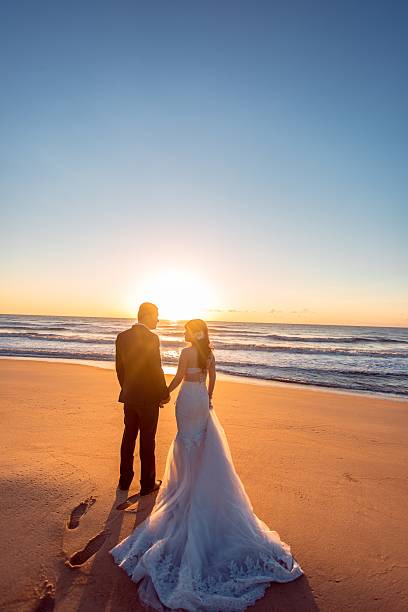 istock Beautiful bride and groom at the beach 521461496