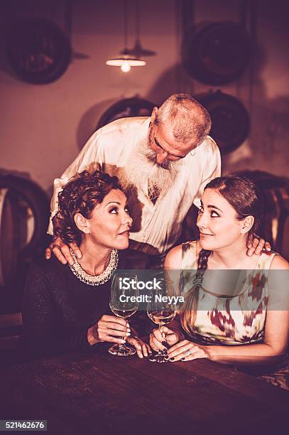 Friends In Wine Cellar Stock Photo - Download Image Now - Active Seniors, Adult, Adults Only