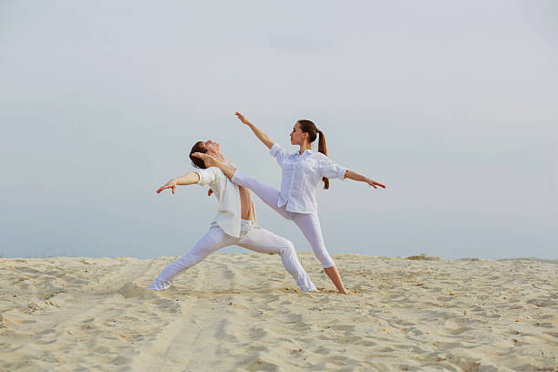 istock beautiful athletic couple workout dance  on the beach 521463018