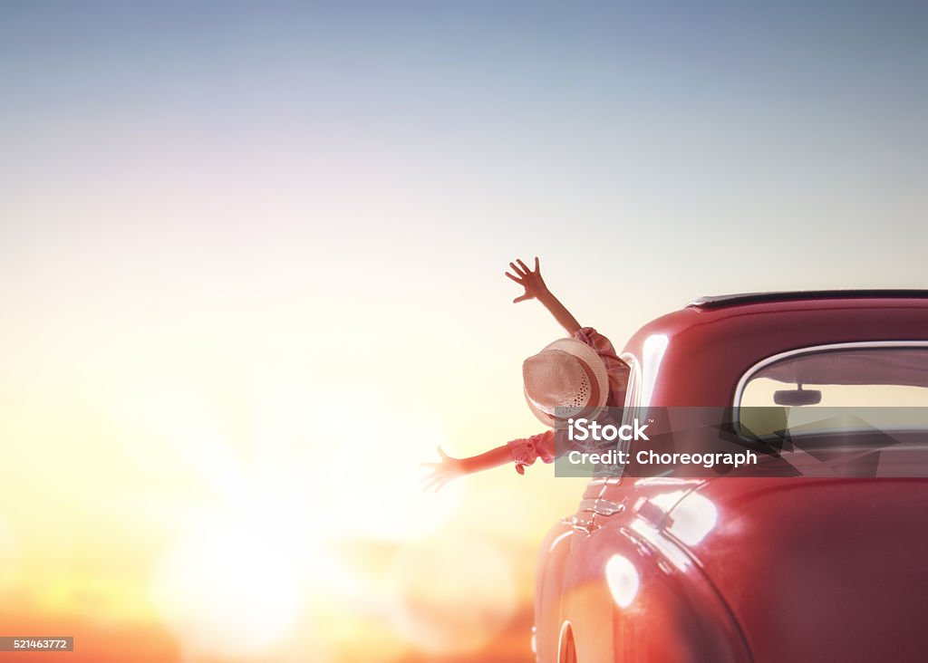 girl rides into the sunset Toward adventure! Girl relaxing and enjoying road trip. Happy girl rides into the sunset in vintage car. Car Stock Photo