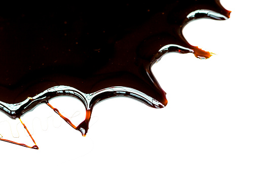 Blackstrap molasses, isolated on white.