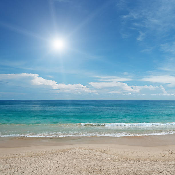 istock Sandy beach and sun in blue sky 521464753